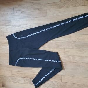 Nike Dri fit running pants. Size small, black with white and black lining.